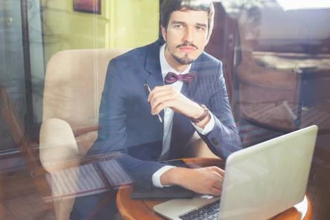 Young businesman working at cafe, using laptop Stock Photos