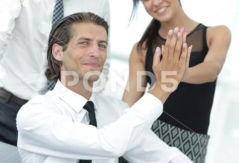 Young business colleagues giving each other a high five Stock Photos