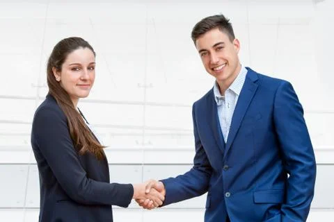 Young business couple shaking hands. Stock Photos