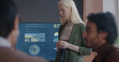 Young business lady making presentation to group of colleagues speaking and Stock Footage 281820165