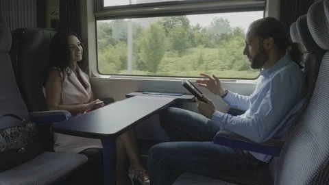 Young business man commuting from work to home using a tablet pc talking and  Stock Footage 102587360