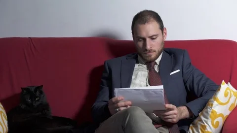 Young business man looking for something in working papers Stock Footage 74722307