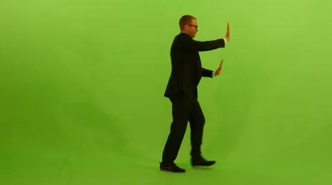 Young business man moving object through room. isolated green screen Stock Footage 64800640