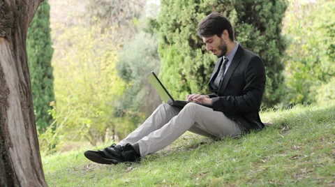 Young business man sitting using tablet Stock-Footage 32577712