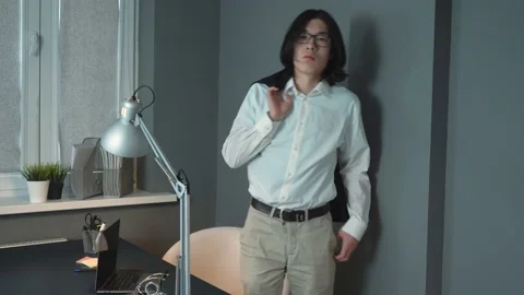 Young Business Man Taking Off Jacket Standing at Office Near His Workplace Stock Footage 148345458