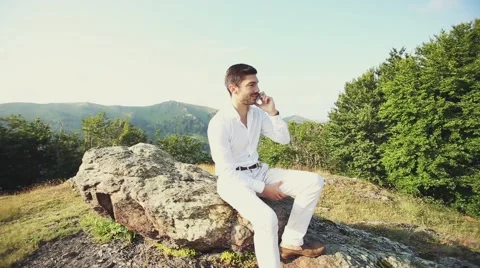 Young business man talking on cell phone at nature. Stock Footage 52319205