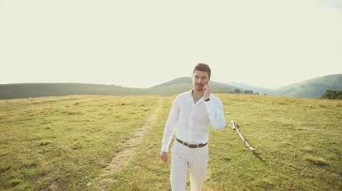 Young business man talking on cell phone at nature. Stock Footage 52320337
