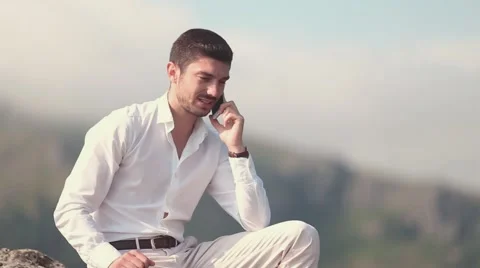 Young business man talking on cell phone at nature. Stock Footage 52330968