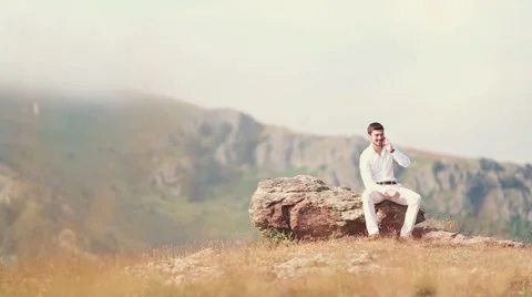 Young business man talking on cell phone at nature. Stock Footage 52332708