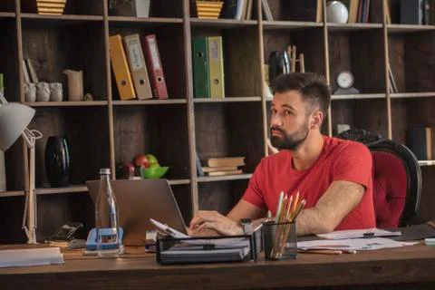 Young business man thinking while working with notebook on what next project Stock Photos