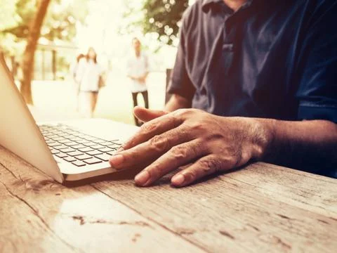 Young business man using computer laptop in coffee shop. Stock Photos