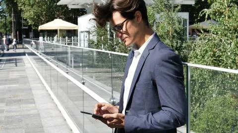 Young business man using tablet computer outdoor Stock Photos