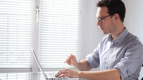Young business man working on computer in the office Stock Footage 98100806