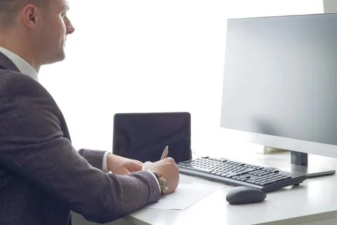 Young business man working at the computer and papers on the table Stock Photos