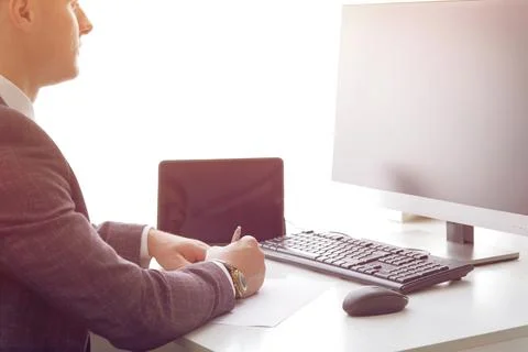 Young business man working at the computer and papers on the table Stock Photos