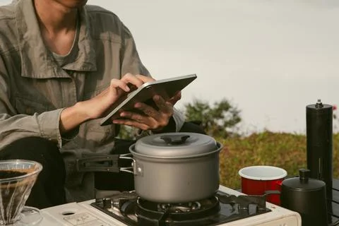 Young business man working computer on peak hill. Hiker online shopping on .. Stock Photos