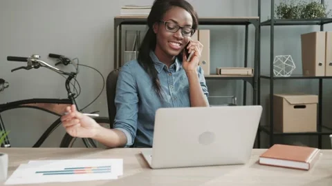 Young business manager talking on cell phone with client and taking notes while Stock Footage 148242466