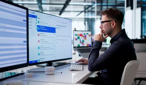Young Business Manager Using Desktop Computer For Client Email Communication. Stock Photos