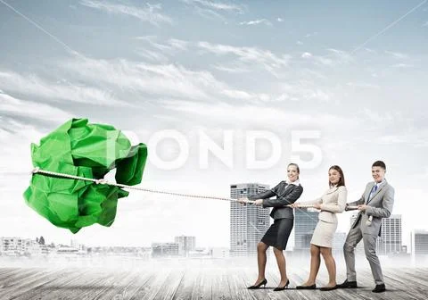 Young business people outdoors and huge paper ball as symbol of creativity Stock Photos