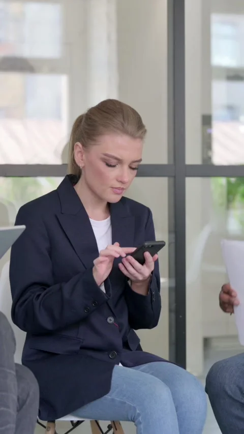 Young Business People using Tablet Smartphone and Documents while Sitting Stock Footage 340038210