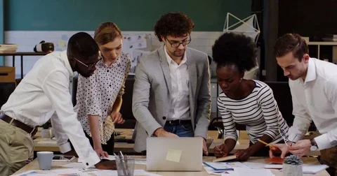 Young business team of multi ethnical office workers checking the data and Stock Footage 82445955