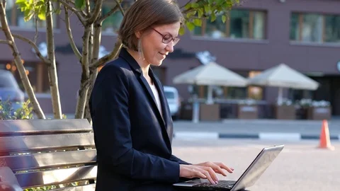Young business woman with notebook pc celebrating, expressing happiness and Stock Footage 115235553