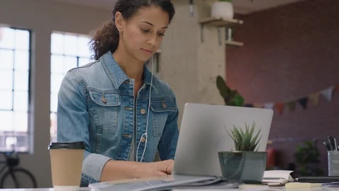 Young business woman using laptop computer typing email messages browsing online Stock Footage