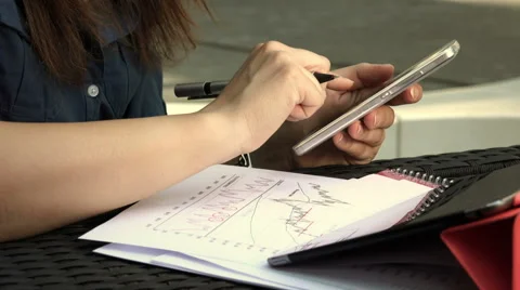 Young businessman analyzing financial data using smartphones and tablet computer Stock-Footage 64796706