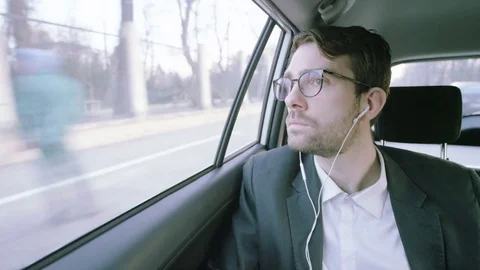 Young Businessman in a Car Looking Through a Window Stock Footage 73786196