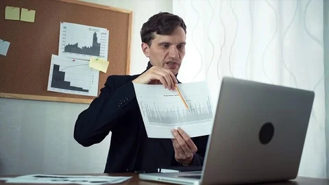 Young businessman chatting with customer using laptop computer Stock Footage 79899907