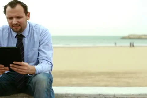 Young businessman chatting on tablet computer, outdoors Видео 10791664