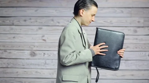 Young businessman dancing with a briefcase Stock Footage 107857345