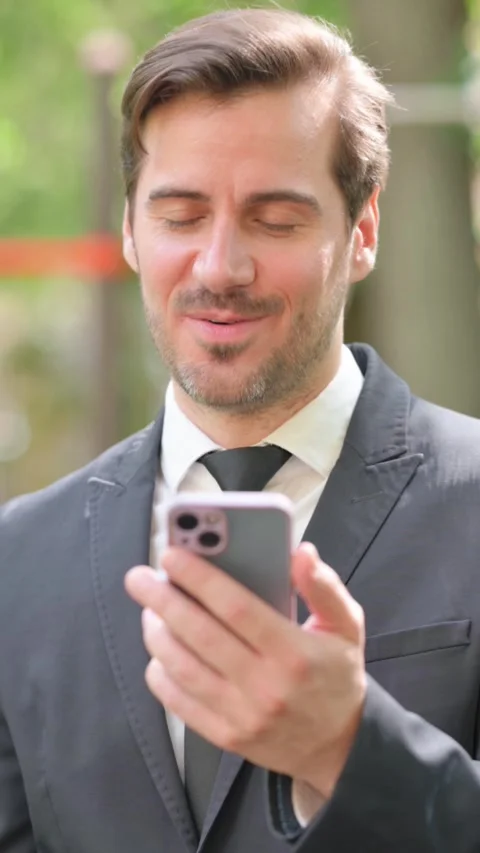 Young Businessman Doing Online Video Talk via Phone Outdoor Stock Footage 319971753