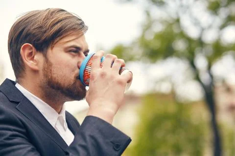 Young businessman drinks coffee while he goes to work Stock Photos