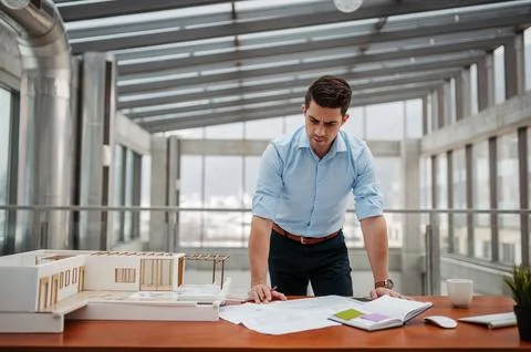 Young businessman, engineer working in office, working on plan or technical Stock Photos
