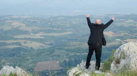 Young businessman escapes from the stress of the his job and climb a hill Stock Footage 59123331