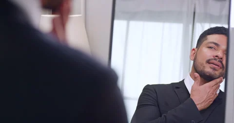 Young businessman gets dressed in front of the mirror before going to work. Stock Footage 270505419