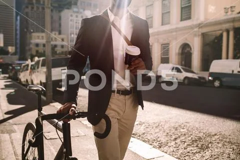 Young businessman going to work by bike Stock Photos