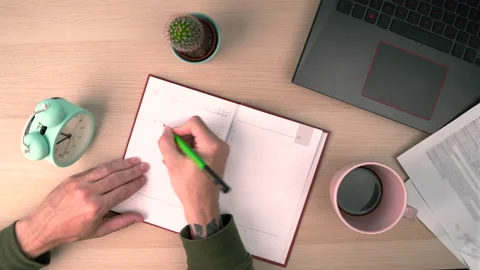 Young businessman hand writing notebook with laptop on wood office desk Stock Footage 201782926