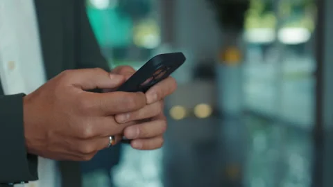 Young businessman hands write message on smartphone in corporate office Video stock 305277706