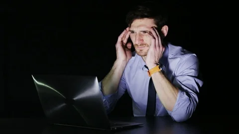 Young Businessman Having a Headache During Overtime Stock Footage 69967202
