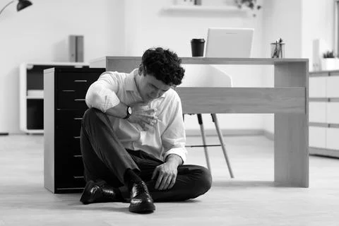 Young businessman having panic attack near desk in office Stock Photos