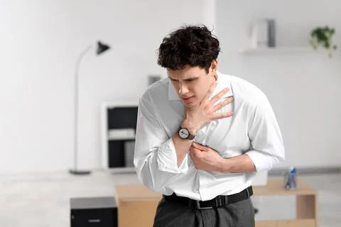 Young businessman having panic attack in office Stock Photos