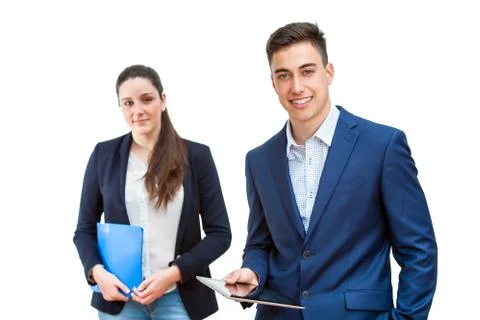 Young businessman holding tablet with female partner in background. Stock Photos