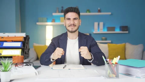 Young businessman looking at camera surprised and rejoicing. Stock Footage 237058397