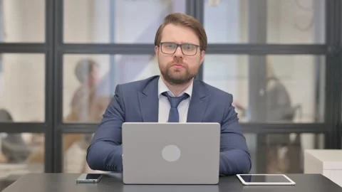 Young Businessman Looking at Camera while Working on Laptop Stock-Footage 273018149