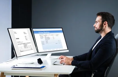 Young Businessman Looking At Invoice While Doing Online Banking Stock Photos
