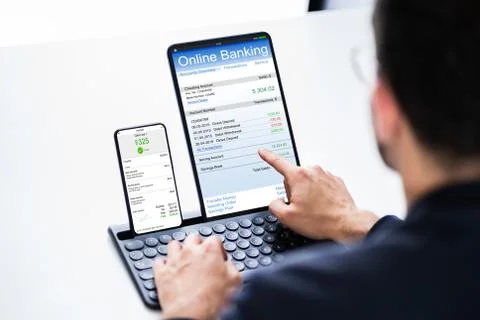 Young Businessman Looking At Invoice While Doing Online Banking Stock Photos