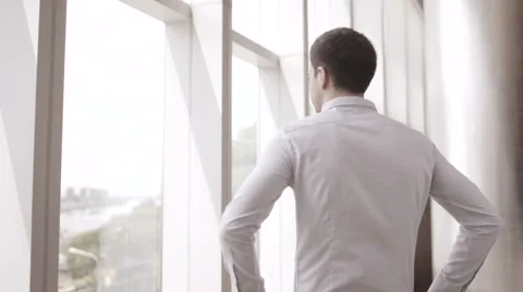 Young Businessman Looking out Window Stock Footage 66480336
