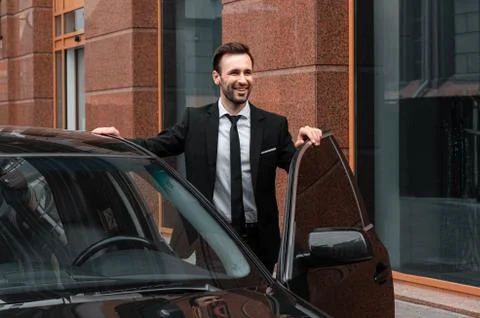 Young businessman near his car. Style of life of a young man. Stock Photos